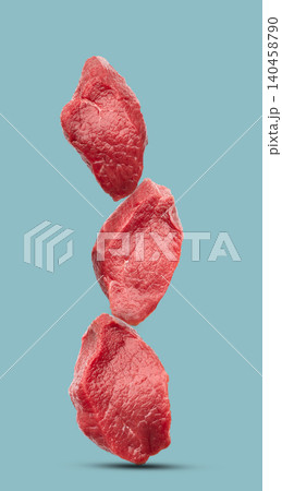 Raw filet mignon on blue background Raw filet mignon on blue background 140458790