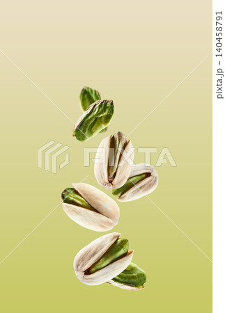 Flying pistachio nuts in closeup on pistachio background 140458791