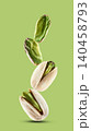 Stack pistachio nuts in closeup on pistachio background 140458793