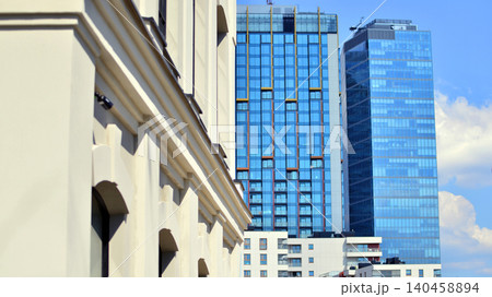 Contrast of old and new buildings in downtown . An ancient building next to a modern skyscraper building. 140458894