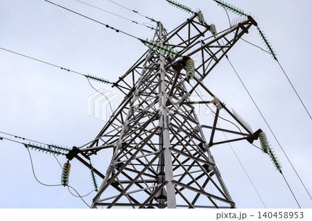Steel electricity pylon with high voltage power lines, transmission tower structure with glass insulators against sky 140458953