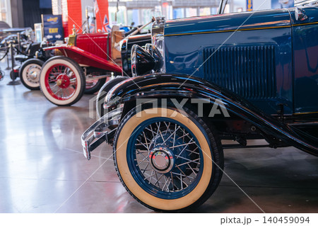 Vintage classic cars with whitewall tires and chrome details displayed inside a retro automobile museum. Historic transportation vehicles create a nostalgic automotive exhibition with elegant early Vintage classic cars with whitewall tires and chrome details displayed inside a retro automobile museum. Historic transportation vehicles create a nostalgic automotive exhibition with elegant early 140459094