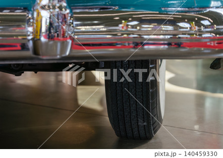 Shiny vintage car with chrome bumper displayed in exhibition hall. Nostalgic atmosphere enhances the clean lines and polished surface of the automobile, inviting admiration. Shiny vintage car with chrome bumper displayed in exhibition hall. Nostalgic atmosphere enhances the clean lines and polished surface of the automobile, inviting admiration. 140459330