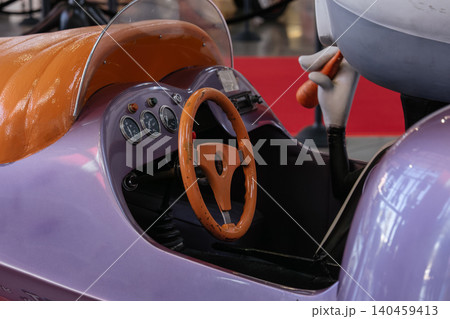 Whimsical toy vehicle with cartoon character holding carrot in amusement park Whimsical toy vehicle with cartoon character holding carrot in amusement park 140459413