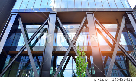 Eco building in modern city concept. Modern office building with the fresh green leaves. Steel and glass. The subject of modern architecture or construction industry. Eco building in modern city concept. Modern office building with the fresh green leaves. Steel and glass. The subject of modern architecture or construction industry. 140459418