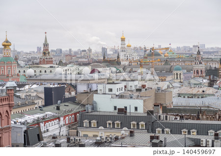 View of Moscows skyline showcasing historic landmarks and ongoing construction with intricate rooftops under a gray, overcast sky. View of Moscows skyline showcasing historic landmarks and ongoing construction with intricate rooftops under a gray, overcast sky. 140459697