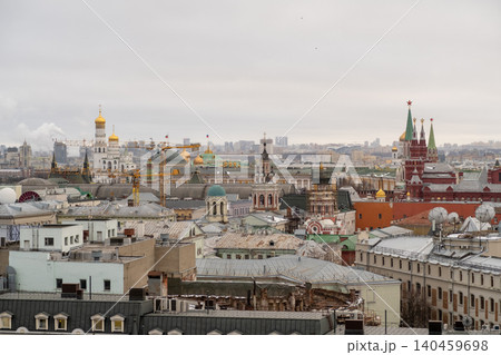 Overview of Moscows skyline showing iconic structures such as cathedrals and the Kremlin, highlighted by a gray sky and urban rooftops below. Overview of Moscows skyline showing iconic structures such as cathedrals and the Kremlin, highlighted by a gray sky and urban rooftops below. 140459698