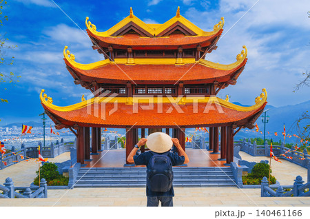back of male tourist at Vietnamese Buddhist Golden Pagoda Truc Lam Phung Thuy Son in Nha Trang in Vietnam. Travel and culture in Vietnam in Asia 140461166