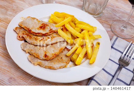 Pork steaks with side dish of crispy fries Pork steaks with side dish of crispy fries 140461417