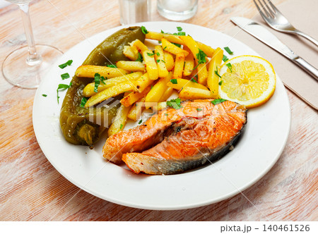 Fresh salmon steak with roasted green pepper and fried potato Fresh salmon steak with roasted green pepper and fried potato 140461526