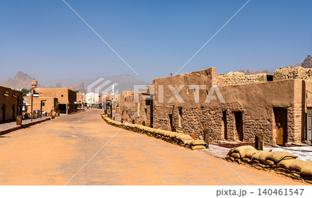 View of the historic mud brick architecture and narrow streets in the Old Town of AlUla, Saudi Arabia, featuring traditional desert construction and mountain backdrops. View of the historic mud brick architecture and narrow streets in the Old Town of AlUla, Saudi Arabia, featuring traditional desert construction and mountain backdrops. 140461547