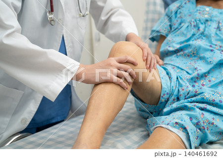 Doctor checking Asian elderly woman patient knee replacement surgery in hospital. Doctor checking Asian elderly woman patient knee replacement surgery in hospital. 140461692