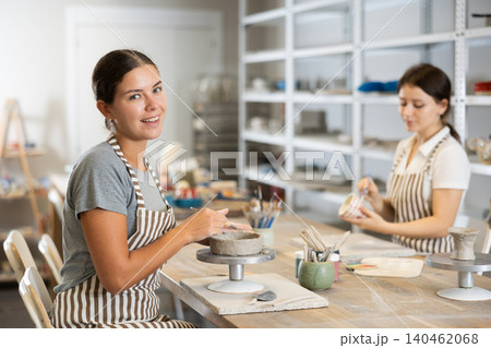 Two young women sculpt and paint ceramics Two young women sculpt and paint ceramics 140462068