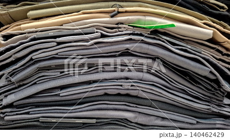 Stack of Folded Trousers and Chino Pants Close Up 140462429