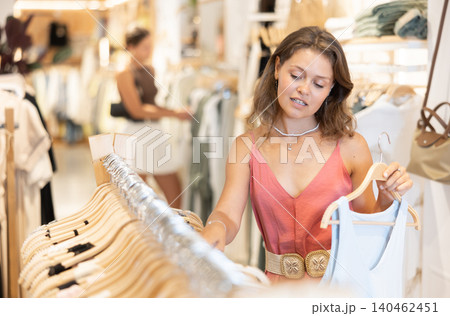 Young woman choosing blouse in clothing store 140462451