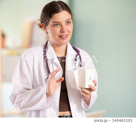 female doctor is standing in her office, she talks about vitamins female doctor is standing in her office, she talks about vitamins 140463181