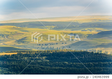 Layers of green mountains and hills in the haze during sunset. Panoramic View of Green hills and Meadow. Layers of green mountains and hills in the haze during sunset. Panoramic View of Green hills and Meadow. 140463999
