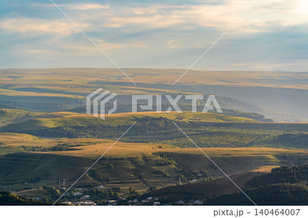 Layers of green mountains and hills in the haze during sunset. Panoramic View of Green hills and Meadow. Layers of green mountains and hills in the haze during sunset. Panoramic View of Green hills and Meadow. 140464007