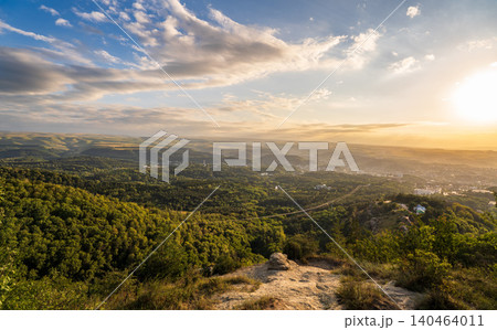 View of the mountains and Kislovodsk from the observation decks of the Kislovodsk Park. Evening sunset over the mountains of Kislovodsk. 140464011