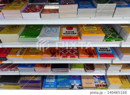 colorful books neatly arranged on the shelves of a shop colorful books neatly arranged on the shelves of a shop 140465188