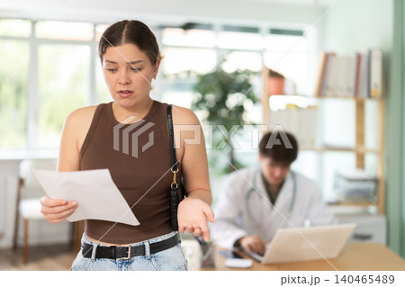 Woman is holding the results of medical testing in her hands, she found out that she was pregnant Woman is holding the results of medical testing in her hands, she found out that she was pregnant 140465489