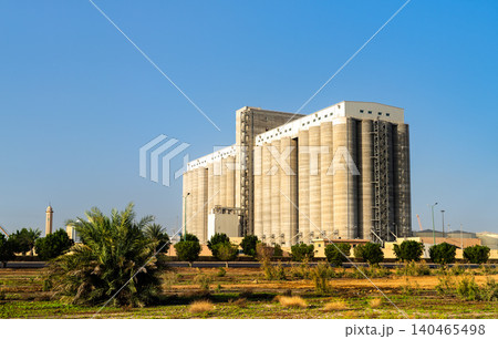 Large concrete grain silos and storage facility standing under a clear blue sky in the port city of Yanbu, Saudi Arabia. Large concrete grain silos and storage facility standing under a clear blue sky in the port city of Yanbu, Saudi Arabia. 140465498