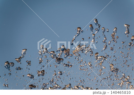 Splashes and jets of water against light background. Splashes and jets of water against light background. 140465810