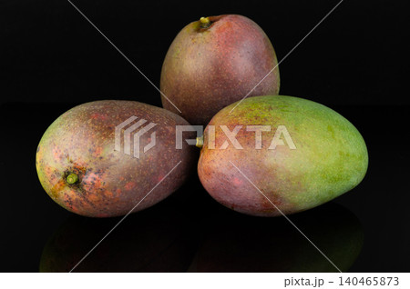 Fresh mangoes stacked on a dark surface 140465873