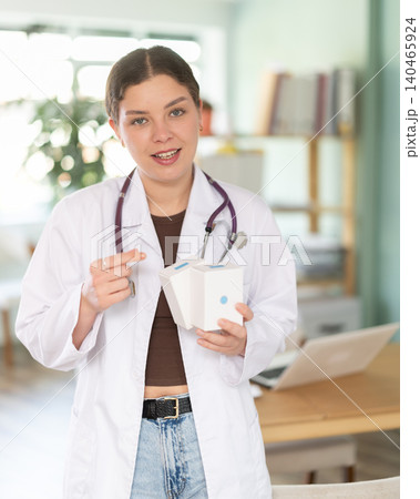 female doctor is standing in her office, she talks about vitamins female doctor is standing in her office, she talks about vitamins 140465924