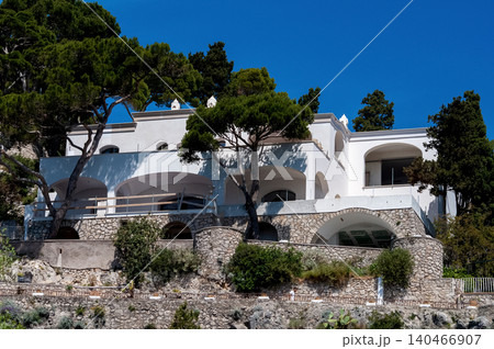 Coastal slopes of the island Capri with luxurious villas located on them. Coastal slopes of the island Capri with luxurious villas located on them. 140466907