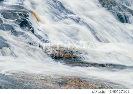 Beautiful waterfall in lush tropical forest, Chiang Mai, Thailand. Nature landscape. Long exposure of water falling on rock of mountainside. A waterfall flows on mountainside. World Water Day concept. 140467162