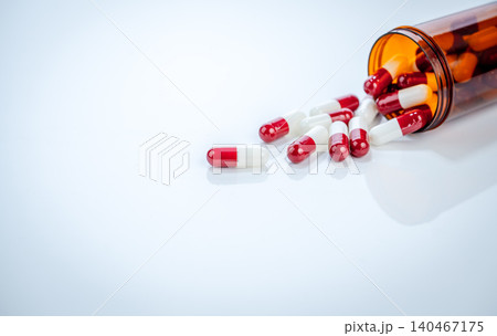 Health policy and medication access concept visualized through scattered red and white pills with prescription bottle. Balance between pharmaceutical innovation and affordable healthcare solutions. Health policy and medication access concept visualized through scattered red and white pills with prescription bottle. Balance between pharmaceutical innovation and affordable healthcare solutions. 140467175