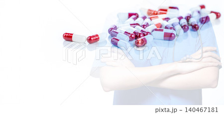 Prescription pills on blurred medical professional in scrubs. Medical Precision. Pharmaceutical capsules juxtaposed with professional healthcare provider. Diagnostic expertise and treatment innovation 140467181