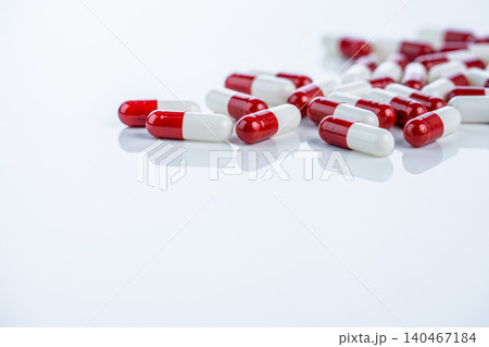 Red white capsules scattered on white background illustrate drug discovery journey from laboratory to market. Pharmaceutical innovation process and rigorous approval stages for new medications Red white capsules scattered on white background illustrate drug discovery journey from laboratory to market. Pharmaceutical innovation process and rigorous approval stages for new medications 140467184