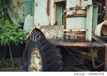 Abandoned rusty truck with weathered storage tank discovered in vehicle graveyard creating atmospheric scene of automotive history and industrial decay. Abandoned rusty truck with weathered storage tank discovered in vehicle graveyard creating atmospheric scene of automotive history and industrial decay. 140467256