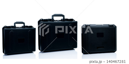 New toolbox or plastic case isolated on white background. Empty hard plastic suitcase with handle. Set of black plastic travel luggage. Modern case for toolkit, drone storage. Black new tool box. New toolbox or plastic case isolated on white background. Empty hard plastic suitcase with handle. Set of black plastic travel luggage. Modern case for toolkit, drone storage. Black new tool box. 140467281