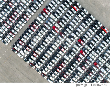 Aerial view of new cars stock at factory parking lot. Above view cars parked in a row. Automotive industry. Logistics business. Import or export new cars at warehouse. Big parking lot at port terminal 140467340