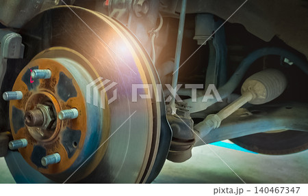 Car disc brake system. Car suspension in process of new tire replacement at garage workshop. Car disc brake mechanic check and repair. Disk break rotor. Car in change tire process at service station. Car disc brake system. Car suspension in process of new tire replacement at garage workshop. Car disc brake mechanic check and repair. Disk break rotor. Car in change tire process at service station. 140467347