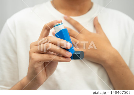 Asthma and chronic obstructive pulmonary disease COPD, Asian teenage using metered dose inhaler MDI. Asthma and chronic obstructive pulmonary disease COPD, Asian teenage using metered dose inhaler MDI. 140467505
