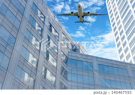Airplane flying in the sky above modern sustainable glass office building. Exterior skyscraper green glass building. Business travel. Aviation business. Air logistics. Cargo plane. Departure flight. Airplane flying in the sky above modern sustainable glass office building. Exterior skyscraper green glass building. Business travel. Aviation business. Air logistics. Cargo plane. Departure flight. 140467593