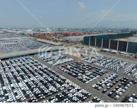 Aerial view of new cars stock at factory parking lot. Above view cars parked in a row. Automotive industry. Logistics business. Import or export new cars at warehouse. Big parking lot at port terminal 140467671