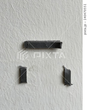 Old adhesive foam tape residue on white wall surface close-up Old adhesive foam tape residue on white wall surface close-up 140470551