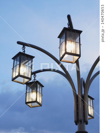 Vintage lantern street lamp glowing against twilight sky Vintage lantern street lamp glowing against twilight sky 140470653