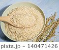 Coarse brown rice in wooden bowl on a blue wooden background top view flat lay 140471426