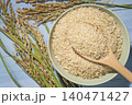 Top view of brown rice in a wooden bowl on a blue wooden background flat lay 140471427