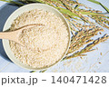 Brown rice bowl with wooden spoon on blue wooden background 140471428