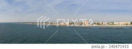 Drone view of sandy beach with umbrellas and gazebos.Summer vacation concept.Lido Adriano town,Adriatic coast, Emilia Romagna,Italy. Drone view of sandy beach with umbrellas and gazebos.Summer vacation concept.Lido Adriano town,Adriatic coast, Emilia Romagna,Italy. 140471433