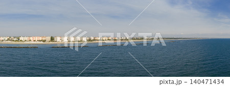 Panorama view of sandy beach with umbrellas and gazebos.Summer vacation concept.Lido Adriano town,Adriatic coast, Emilia Romagna,Italy. Panorama view of sandy beach with umbrellas and gazebos.Summer vacation concept.Lido Adriano town,Adriatic coast, Emilia Romagna,Italy. 140471434