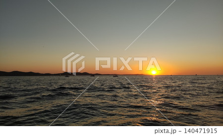 Sunset over adriatic sea in croatia with sailboats at dusk during summer vacation Sunset over adriatic sea in croatia with sailboats at dusk during summer vacation 140471915