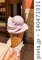 Hand holding delicious lavender ice cream cone in croatia during summer vacation 140471931